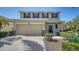 Two-story home with a two-car garage, manicured landscaping, and a covered front porch at 5403 Mang Pl, Sarasota, FL 34238