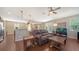 Open-concept living room with hardwood floors, comfortable seating, and plenty of natural light at 5403 Mang Pl, Sarasota, FL 34238