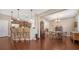 Open-concept living room and kitchen with hardwood floors and stainless steel appliances at 5403 Mang Pl, Sarasota, FL 34238