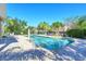 Community pool surrounded by palm trees offers a relaxing retreat on a sunny day at 5403 Mang Pl, Sarasota, FL 34238