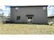 A view of the backyard from the exterior with a sliding glass door at 5430 Amaryllis Garden St, Apollo Beach, FL 33572