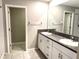 Bright bathroom features double sinks, granite counters, and an open doorway to the toilet and shower area at 5430 Amaryllis Garden St, Apollo Beach, FL 33572