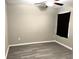 This bedroom has a ceiling fan, gray walls and gray laminate flooring at 5430 Amaryllis Garden St, Apollo Beach, FL 33572