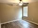 Bedroom featuring a ceiling fan, window, gray laminate flooring and closet at 5430 Amaryllis Garden St, Apollo Beach, FL 33572