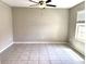 Bedroom with neutral walls, tile flooring and a window at 5430 Amaryllis Garden St, Apollo Beach, FL 33572