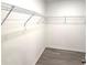 Walk-in closet with wire shelving and gray laminate flooring at 5430 Amaryllis Garden St, Apollo Beach, FL 33572