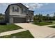 Two-story home with a wide driveway, well-kept lawn, and tasteful landscaping at 5430 Amaryllis Garden St, Apollo Beach, FL 33572