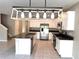 Spacious kitchen with modern appliances, an island with a sink, and granite countertops at 5430 Amaryllis Garden St, Apollo Beach, FL 33572