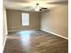 The Living Room features gray laminate flooring and a window at 5430 Amaryllis Garden St, Apollo Beach, FL 33572