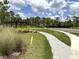 Community park with a pergola, landscaping, grass, and a well maintained paved walking path at 5430 Amaryllis Garden St, Apollo Beach, FL 33572