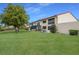 Expansive backyard featuring lush green grass and partial building view with screened-in patio at 5625 15Th Ave W, Bradenton, FL 34209