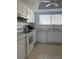 Well-lit kitchen featuring white appliances, white cabinets and granite countertops at 5625 15Th Ave W, Bradenton, FL 34209