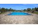 Enjoy this sparkling blue pool surrounded by a beautiful patio deck, lounge chairs and manicured landscaping at 5625 15Th Ave W, Bradenton, FL 34209