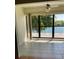 Bright sun room featuring tile floors, ceiling fan and beautiful water view at 5625 15Th Ave W, Bradenton, FL 34209