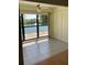 Bright sun room featuring tile floors, ceiling fan and beautiful water view with fountain at 5625 15Th Ave W, Bradenton, FL 34209