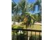 Relax on this balcony surrounded by lush tropical palm trees and landscaping, perfect for enjoying the weather at 5741 Soldier Cir # 202, Sarasota, FL 34233