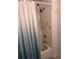 Bathroom featuring a shower with a stylish curtain and a bathtub with tiled walls at 5741 Soldier Cir # 202, Sarasota, FL 34233