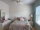 Bright bedroom features a ceiling fan and a comfortable bed with colorful pillows at 5741 Soldier Cir # 202, Sarasota, FL 34233