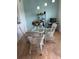 Bright dining area with a glass table, white wicker chairs, and natural light from nearby windows at 5741 Soldier Cir # 202, Sarasota, FL 34233