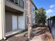 Exterior of condo unit with dark metal fencing and tropical palm tree at 5741 Soldier Cir # 202, Sarasota, FL 34233