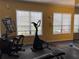 Well-lit gym with elliptical and stairmaster equipment by windows at 5741 Soldier Cir # 202, Sarasota, FL 34233