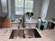 Kitchen area featuring stainless steel sink, quartz countertops and modern fixtures at 5741 Soldier Cir # 202, Sarasota, FL 34233