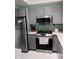 Modern kitchen with gray cabinets, stainless steel appliances, and light countertops at 5741 Soldier Cir # 202, Sarasota, FL 34233
