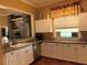 Kitchen featuring ample counter space, white cabinets, and a convenient sink setup at 5741 Soldier Cir # 202, Sarasota, FL 34233