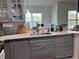 Kitchen area featuring stainless steel sink, quartz countertops, grey cabinets at 5741 Soldier Cir # 202, Sarasota, FL 34233