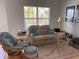 Inviting living room with comfortable seating arrangement and natural light from the window at 5741 Soldier Cir # 202, Sarasota, FL 34233