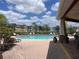 Inviting community pool surrounded by lounge chairs and lush landscaping at 5741 Soldier Cir # 202, Sarasota, FL 34233