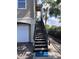Inviting staircase leading to a charming condo with a private entrance and a glimpse of a palm tree at 5741 Soldier Cir # 202, Sarasota, FL 34233