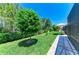 Lush backyard featuring mature trees, manicured lawn, and comfortable patio seating at 5957 Amberly Dr, Bradenton, FL 34208