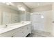 Modern bathroom with double sinks, a glass-enclosed shower with white subway tile, and upscale fixtures at 5957 Amberly Dr, Bradenton, FL 34208