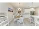 Bright dining area features a chandelier, seating for four, and is adjacent to the kitchen at 5957 Amberly Dr, Bradenton, FL 34208