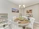 Dining room with a wooden table, decorative chandelier, and built-in wine storage at 5957 Amberly Dr, Bradenton, FL 34208
