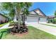Charming home showcasing a well-manicured lawn, garden, and a spacious two-car garage at 5957 Amberly Dr, Bradenton, FL 34208