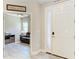 Bright foyer with wood-look tile floors leads into a living area with comfortable seating and a ceiling fan at 5957 Amberly Dr, Bradenton, FL 34208