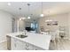 Bright kitchen featuring a quartz countertop island with seating and stainless steel appliances at 5957 Amberly Dr, Bradenton, FL 34208