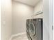 Convenient laundry room with modern washer and dryer, shelving, and neutral paint at 5957 Amberly Dr, Bradenton, FL 34208