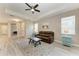 Inviting living room with a tray ceiling, ceiling fan, neutral colors, and wood-look tile flooring at 5957 Amberly Dr, Bradenton, FL 34208