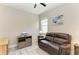 Bright room with a leather sofa, ceiling fan, and ample desk space for comfort and productivity at 5957 Amberly Dr, Bradenton, FL 34208