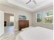 Spacious main bedroom with a flat screen TV, decorative dresser and a beautiful backyard view at 5957 Amberly Dr, Bradenton, FL 34208