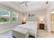 This main bedroom features a ceiling fan, wood-look tile flooring, and large windows at 5957 Amberly Dr, Bradenton, FL 34208