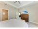 Bedroom features wood-look tile flooring, ensuite bathroom, and a calming aesthetic at 5957 Amberly Dr, Bradenton, FL 34208