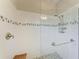 Shower featuring subway tile and a glass enclosure, with built in shower caddy and decorative accent tiles at 5957 Amberly Dr, Bradenton, FL 34208