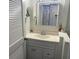 Bright bathroom vanity with mirror, lighting, and a view into a bedroom with a closet at 6157 E Midnight Pass Rd # B51, Sarasota, FL 34242