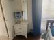 White nightstand next to a window with natural light in the bedroom at 6157 E Midnight Pass Rd # B51, Sarasota, FL 34242