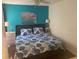 Bedroom featuring a plush bed with decorative pillows and a calming teal accent wall at 6157 E Midnight Pass Rd # B51, Sarasota, FL 34242