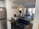 Compact kitchen with stainless appliances, granite counters and breakfast bar at 6157 E Midnight Pass Rd # B51, Sarasota, FL 34242